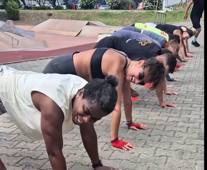 Participantes lado a lado a fazer flexões